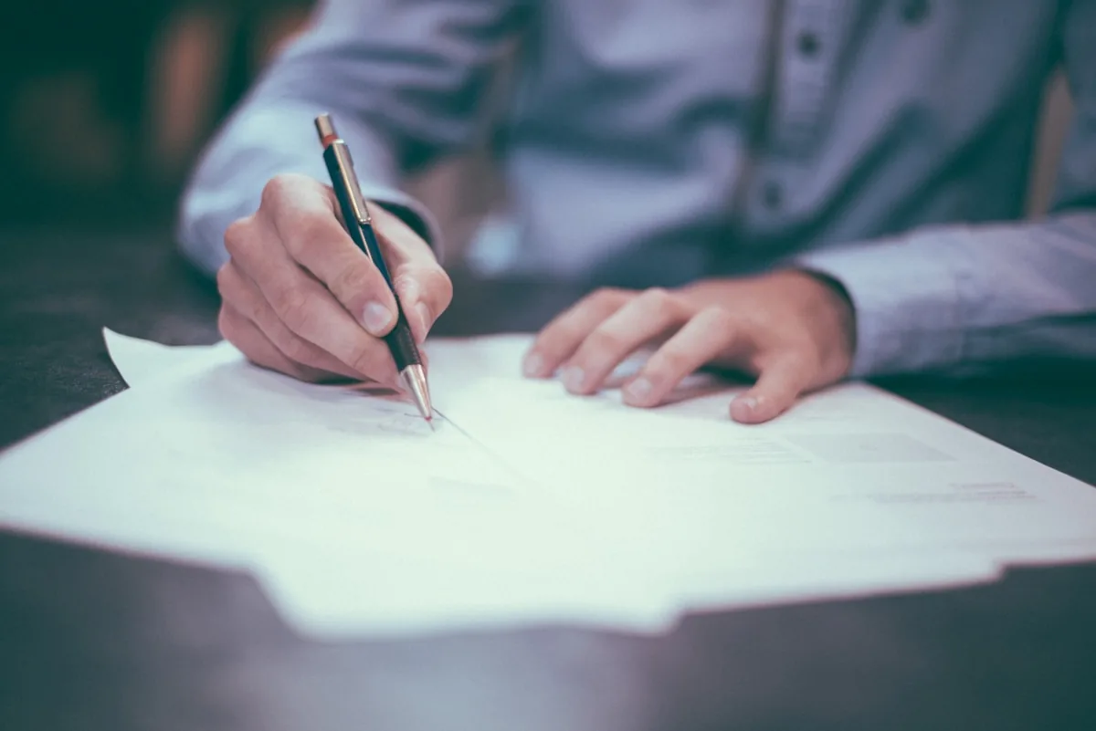 Family reviewing estate and trust documents with a financial advisor at a desk
