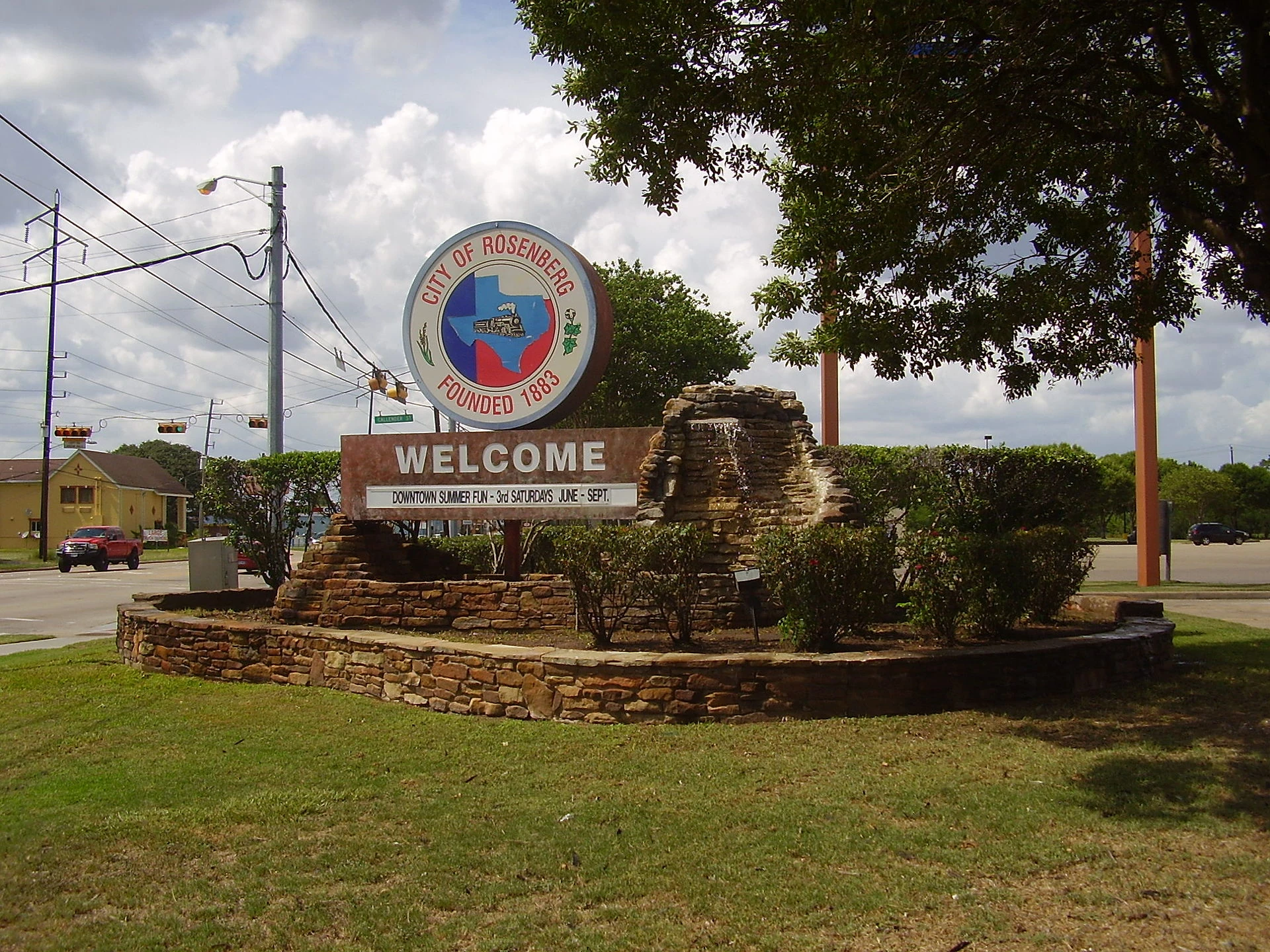 City of Rosenberg welcome sign, with the city seal showing a locomotive and the words Founded 1883